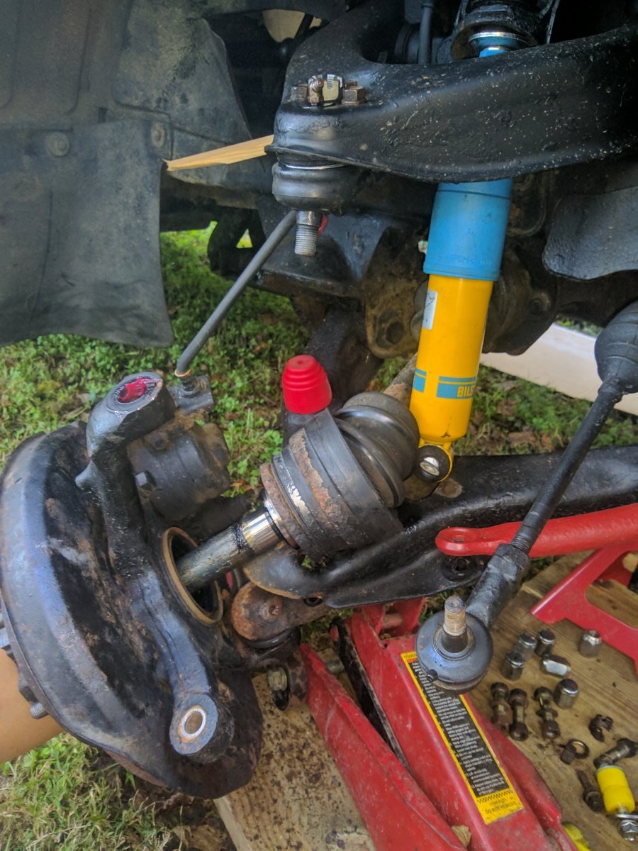 Hub, knuckle, and brake caliper assembly hung from the chassis by wire