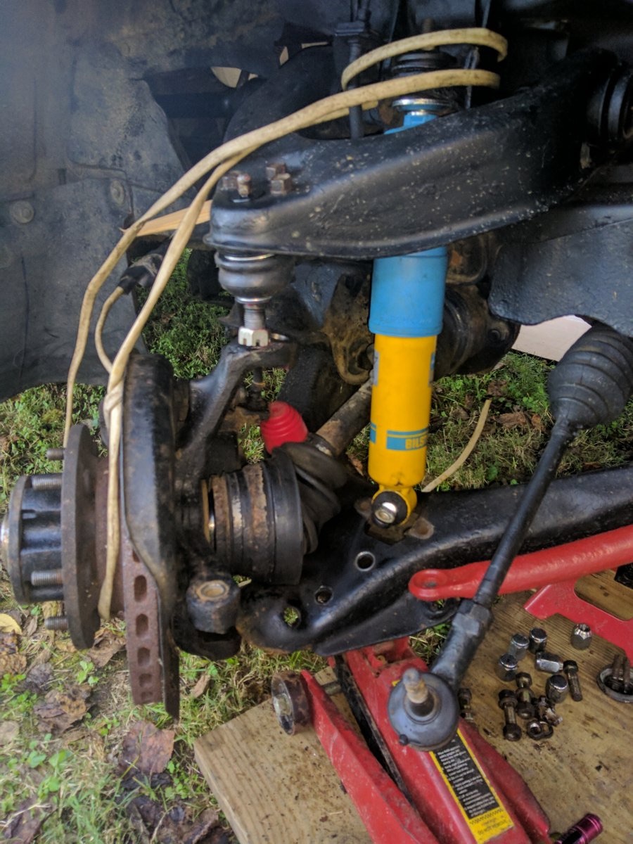Knuckle, hub, CV joint, and shock hanging free after the sequence above